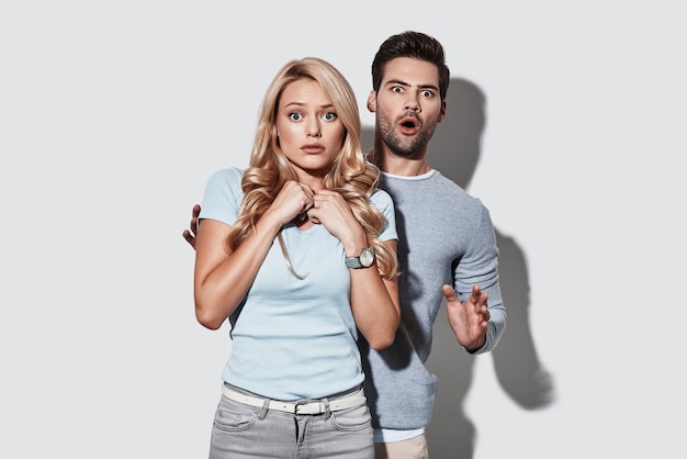 Real shock. Terrified young couple making a face 