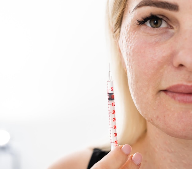 Real skin Biorevitalization on white background. Traces of biorevitalization injections on woman face. Biorevitalization needle marks Beauty treatment, real papules after hyaluronic injection.