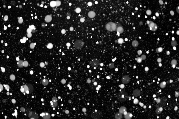 Foto texture di neve reale bokeh su sfondo nero