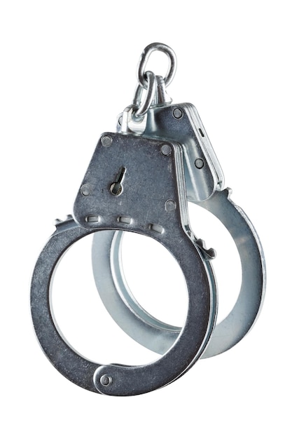 Real zinc plated steel police handcuffs closed isolated on white background