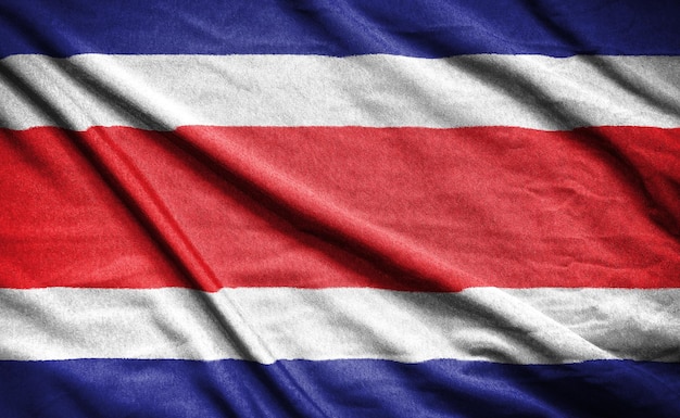 Realistic flag of costa rica on the wavy surface of fabric