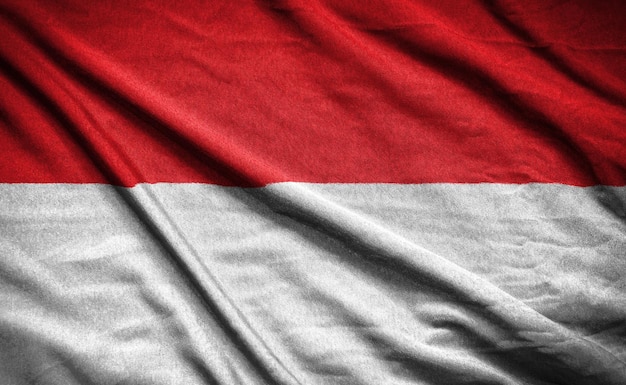 Realistic flag of indonesia on the wavy surface of fabric