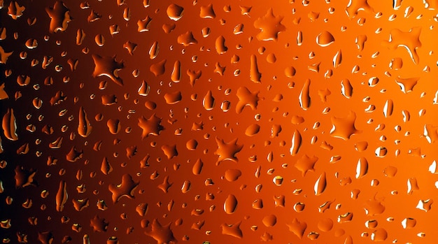 Realistic water drops on abstract orange to black gradient background transparent surface