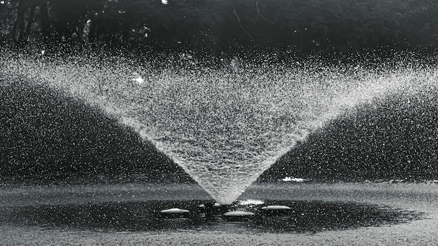 Realistic water fountain. fountains with water jets over pond in public park.