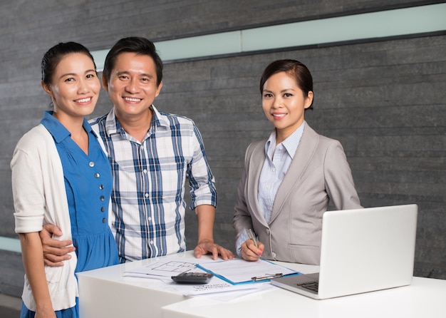 Realtor and cheerful couple