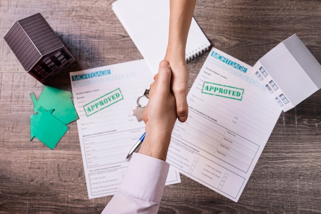 realtor and client shaking hands in agreement