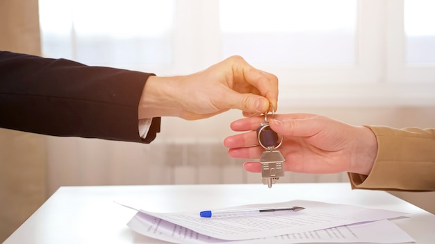 Realtor gives keys to lady after signing of rental contract