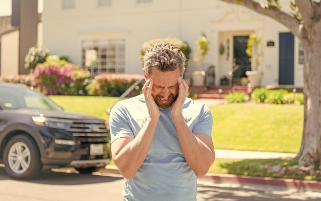 Realtor having headache at new house outdoor ownership concept