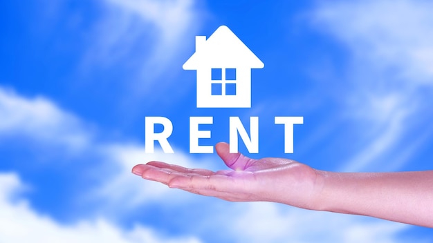 Realtors hand puts with icon house and word RENT Concept of renting housing apartment real estate market of immobility Property investment and house mortgage financial concept