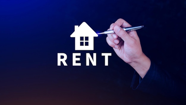 Realtors hand puts with icon house and word RENT Concept of renting housing apartment real estate market of immobility Property investment and house mortgage financial concept