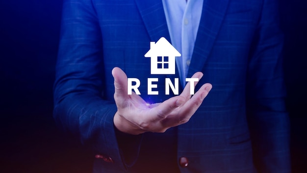 Realtors hand puts with icon house and word RENT Concept of renting housing apartment real estate market of immobility Property investment and house mortgage financial concept