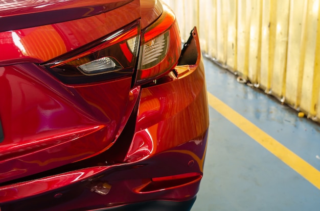 Rear bumper dented red car