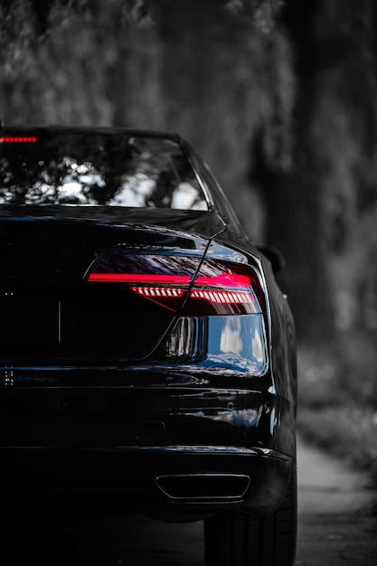 Photo rear light of a modern black car. detail of car. concept of expensive, sports auto.