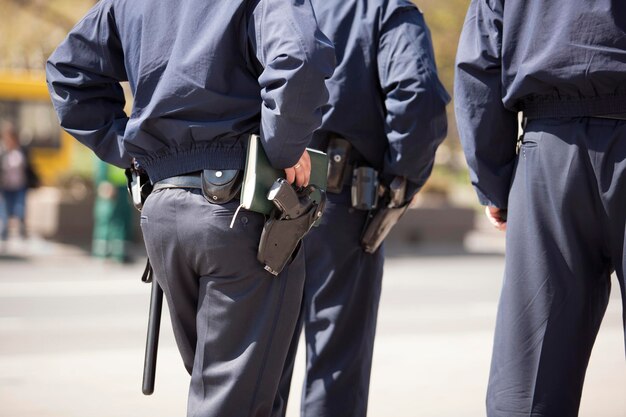 Photo rear midsection of police force on street