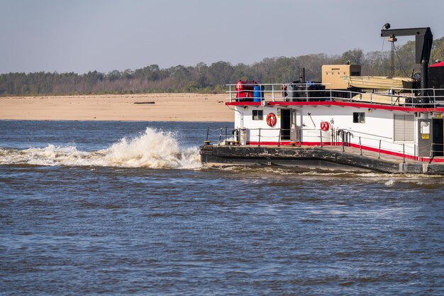 Rear of mississippi river pusher boat churning the water