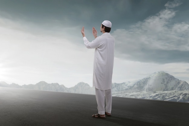 Rear view of asian muslim man praying