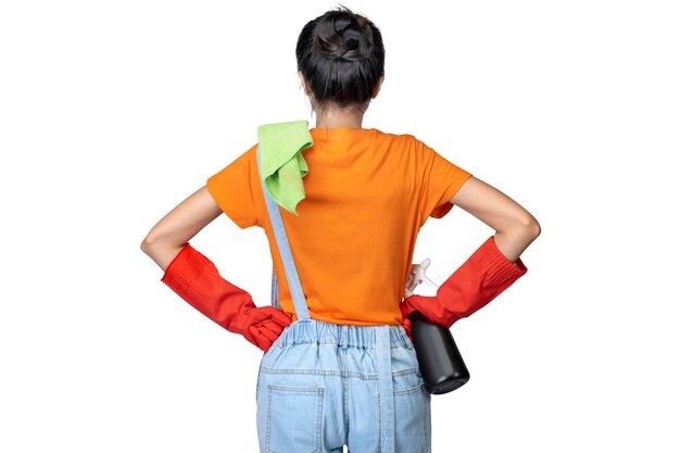 Rear view of an Asian young housewife in a protective glove holding a bottle sprayer