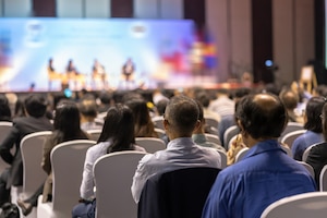 Rear view of audience listening in the conference