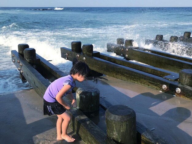 Rear view of boy looking at sea