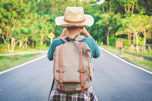 Rear view of boy standing on road