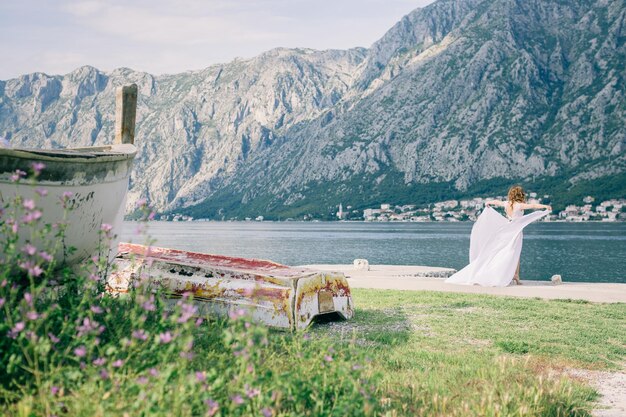 Rear view of bride standing by river