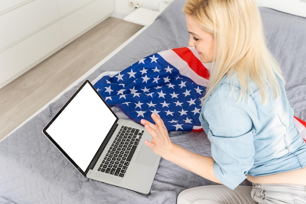 Rear view of business woman hands busy using laptop at office desk, with copyspace.