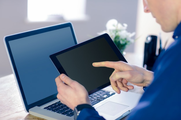 Rear view of businessman using tablet