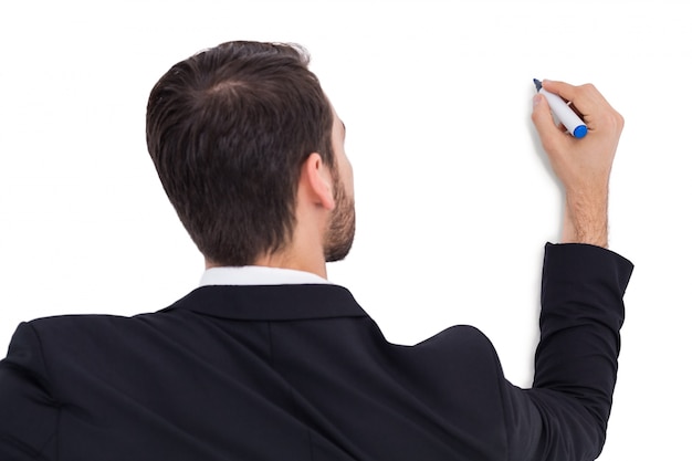 Rear view of businessman writing with marker