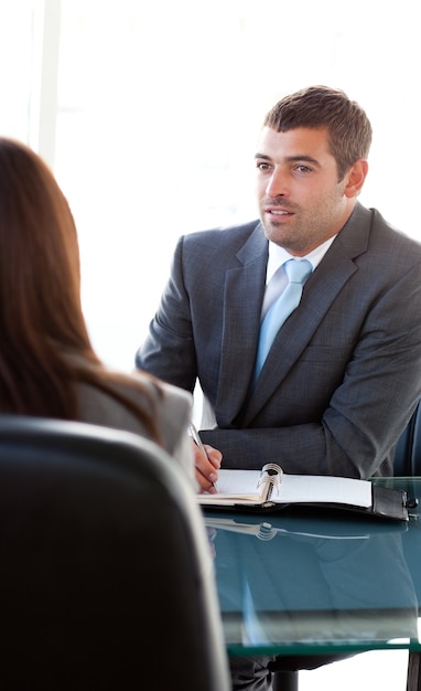 Rear view of a businesswoman talking with a charismatic businessman