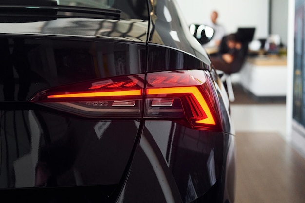 Rear view of the car Close up focused view of brand new modern black automobile