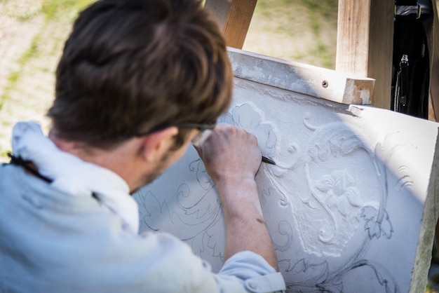 Rear view close-up of man working outdoors