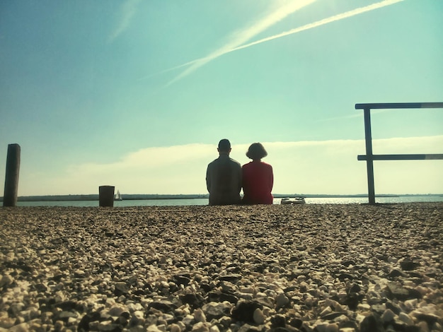 Foto vista posteriore di una coppia con vista sul mare calmo