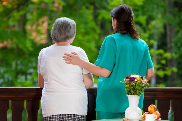 rear view of couple standing by flowering plants