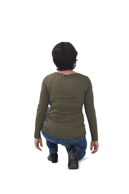 Rear view of a crouching woman on white background