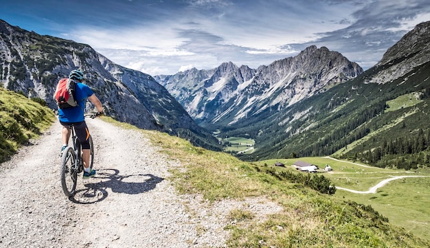 Photo rear view of cyclist on country road