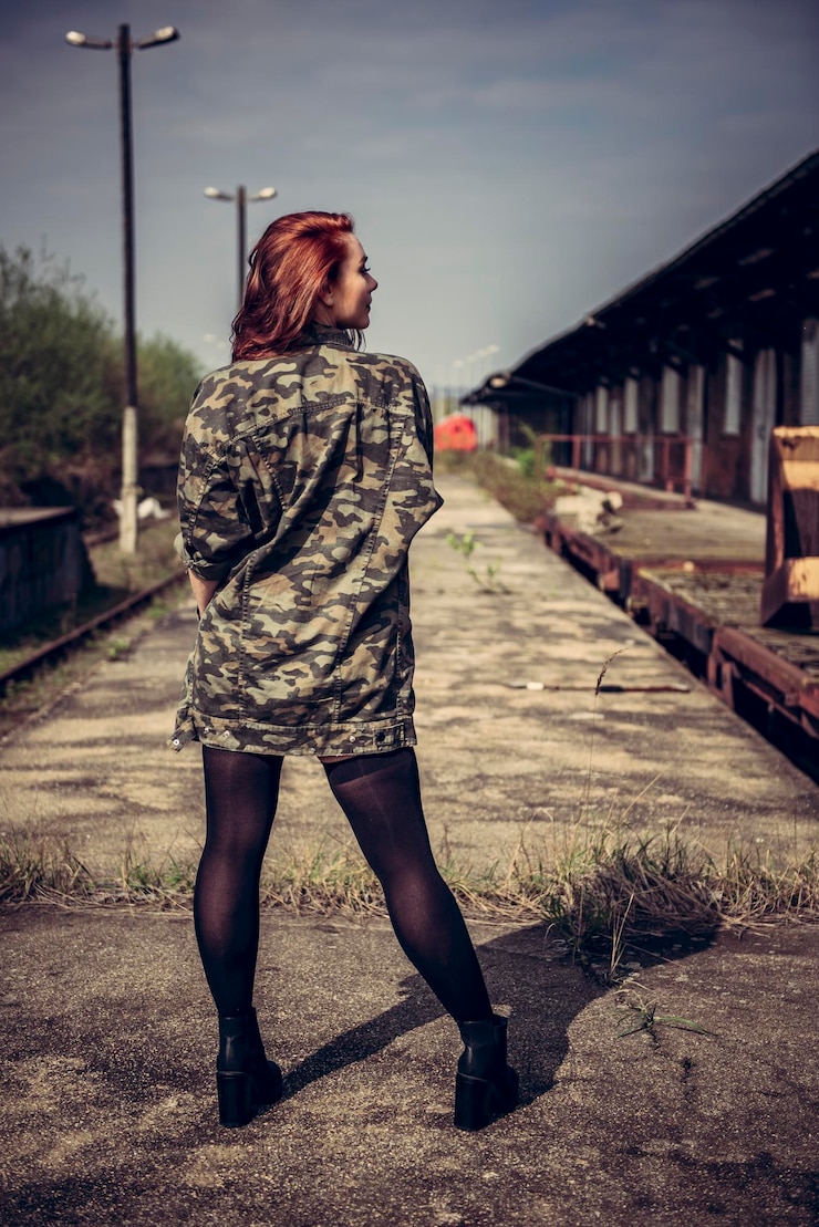 Фотография задний вид полной длины молодой женщины, стоящей на тротуаре