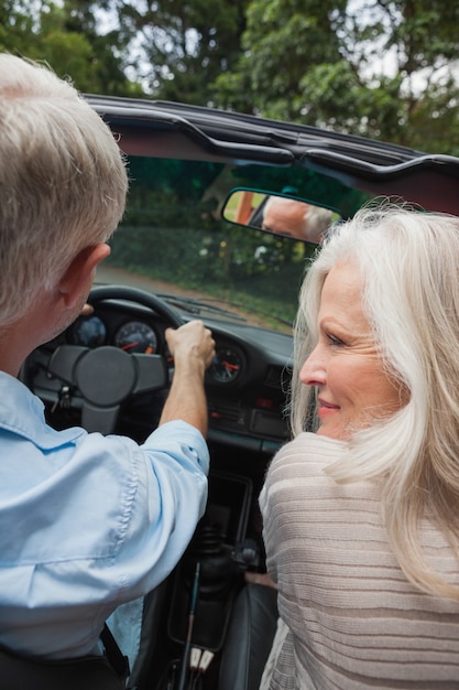 Rear view of happy mature couple going for a ride together