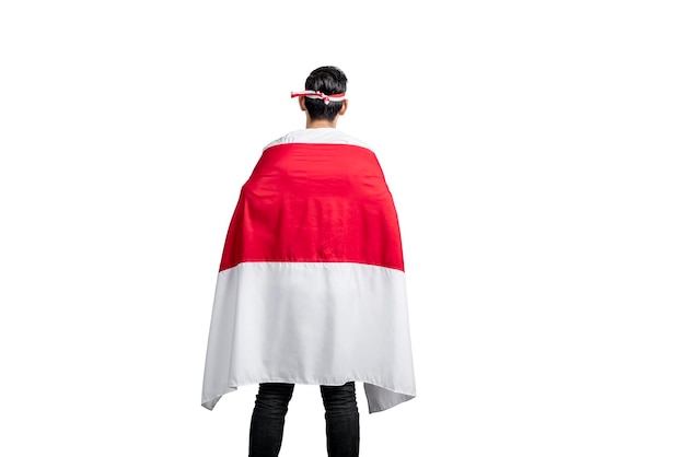 Rear view of Indonesian men celebrating Indonesian independence day on 17 August by holding the Indonesian flag