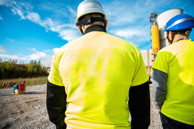 A rear view of an industrial man engineer at factory