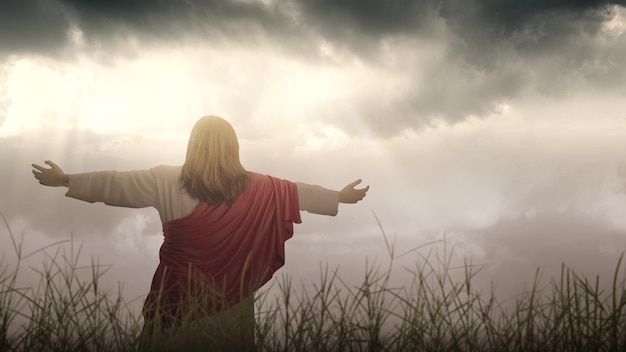 Photo rear view of jesus christs raised hands and praying to god