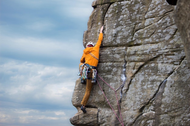 Rear view of man climbing on rock