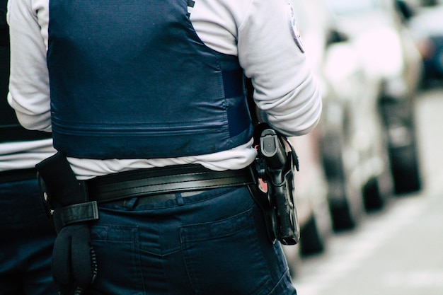 Rear view of man holding mobile phone in city