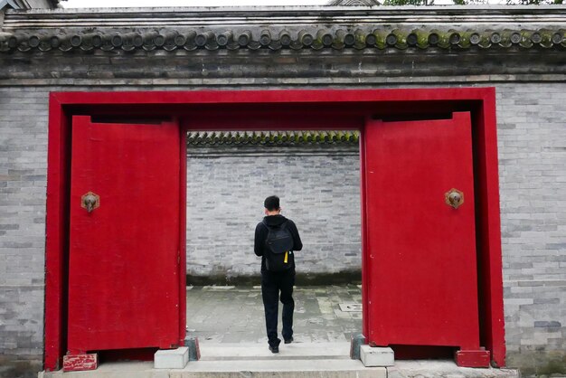 Rear view of man looking at entrance of building