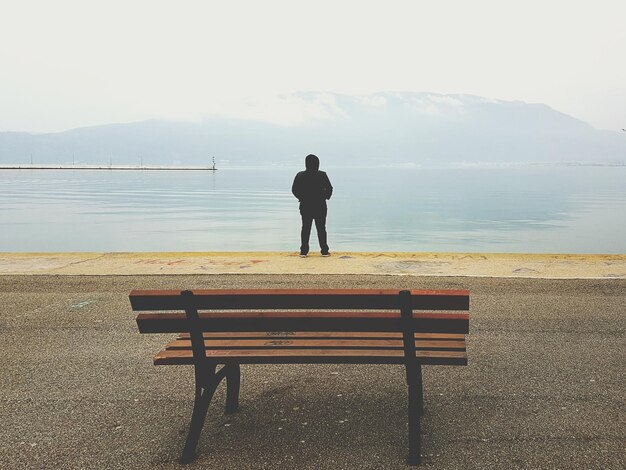 Rear view of man looking at sea