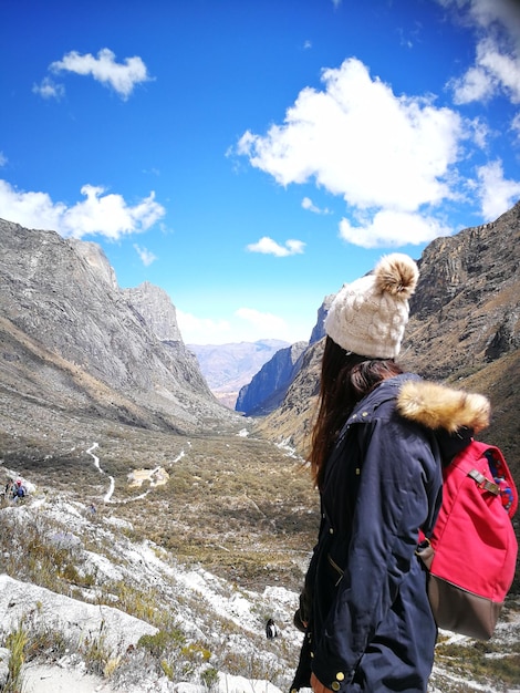 Rear view of man on mountain against sky