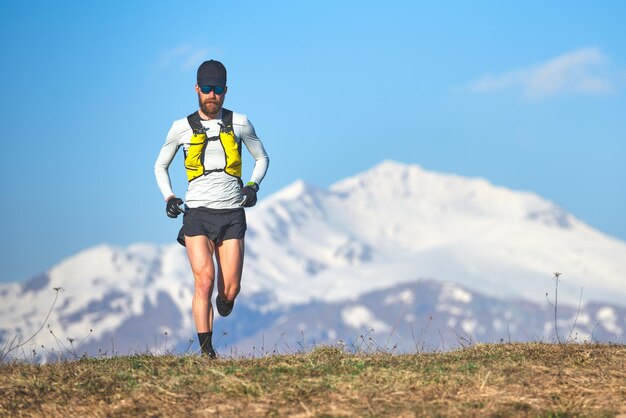 Rear view of man on mountain against sky