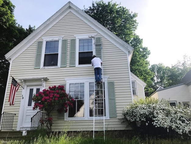 Photo rear view of man outside house against sky