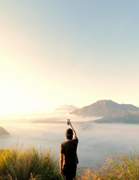 rear view of man photographing against sky