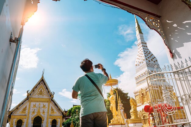 Rear view of man photographing temple