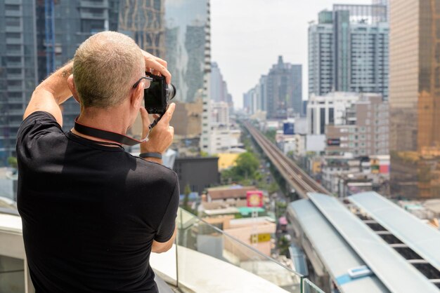 Rear view of man photographing